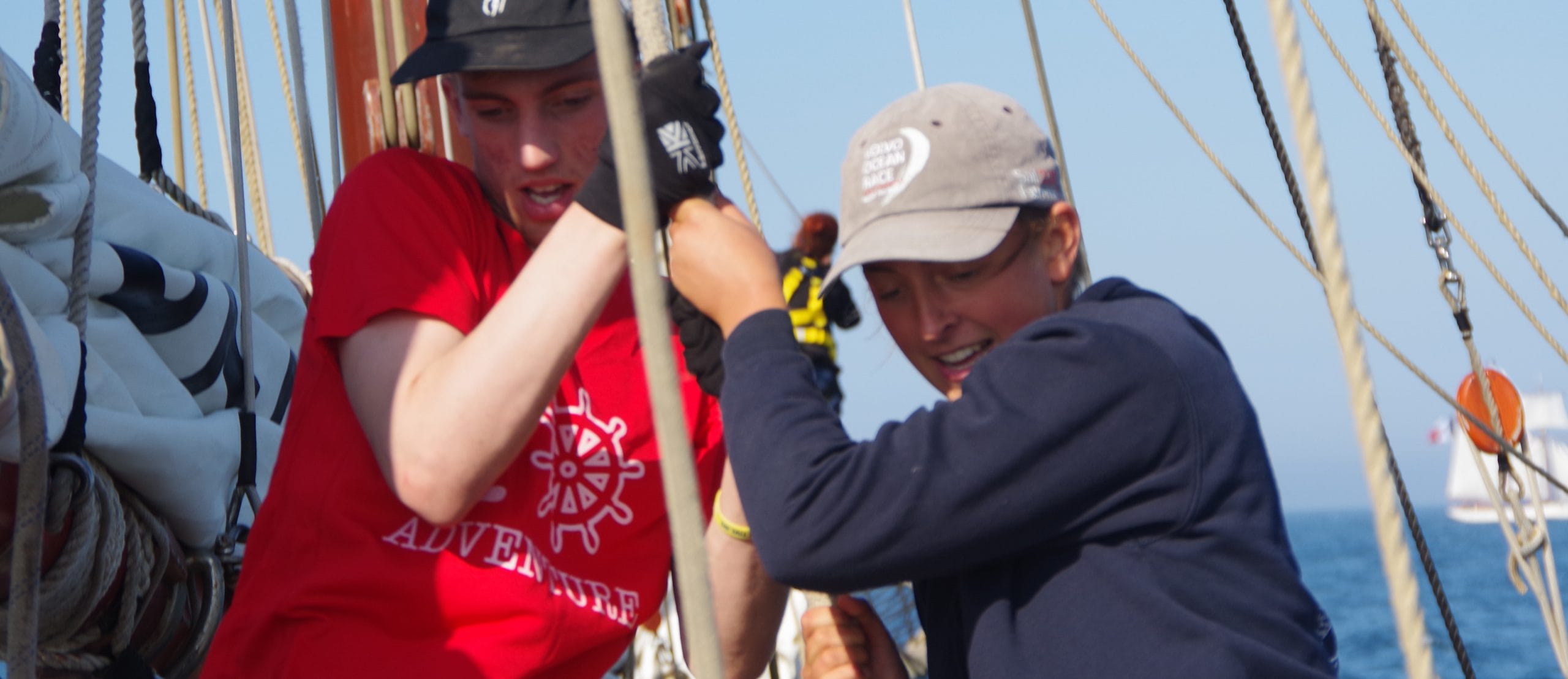 Participants trainees pulling ropes challenge physical mentoring guidance sailing tall ship training ship Atyla