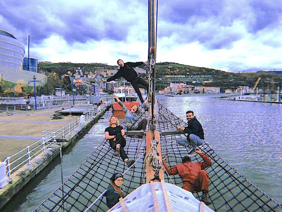 Fotografia de grupo de um navio a fazer voluntariado em Bilbau a divertir-se no Estádio Anoeta Rio Stuary